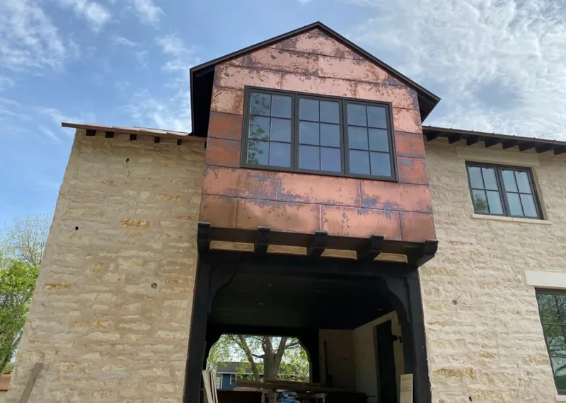 Copper metal panel facade on a stone building for Skylight Installation in Lone Tree